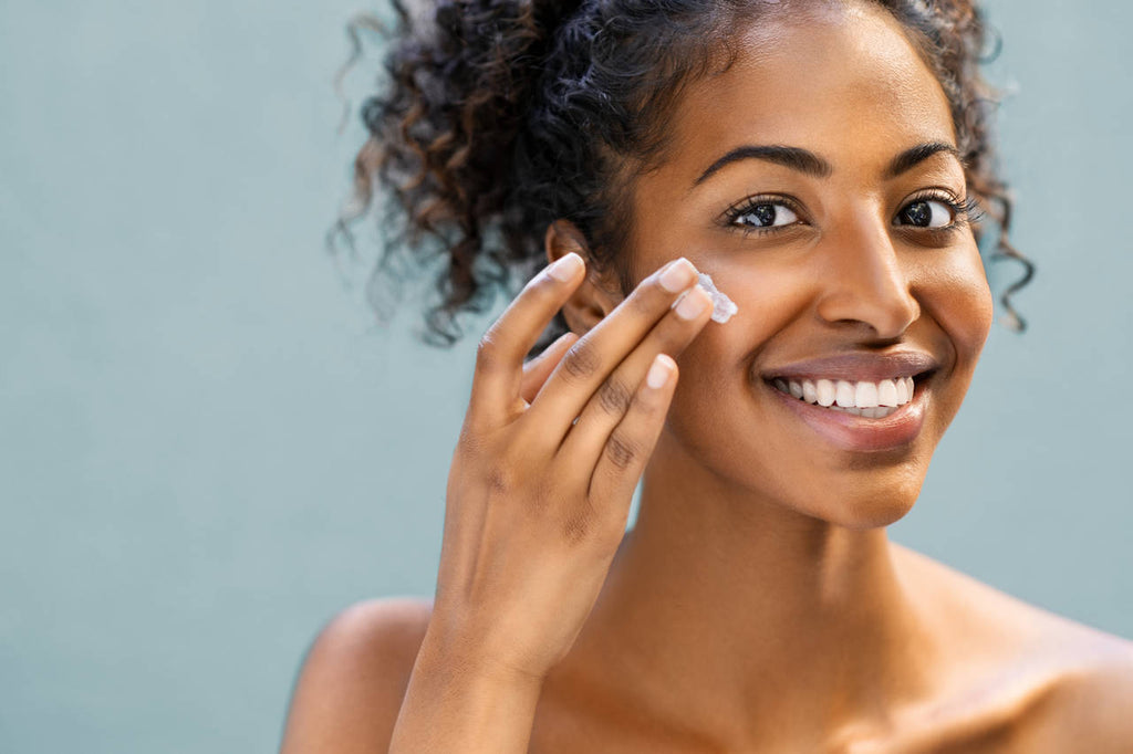 Woman applying skincare product to her face